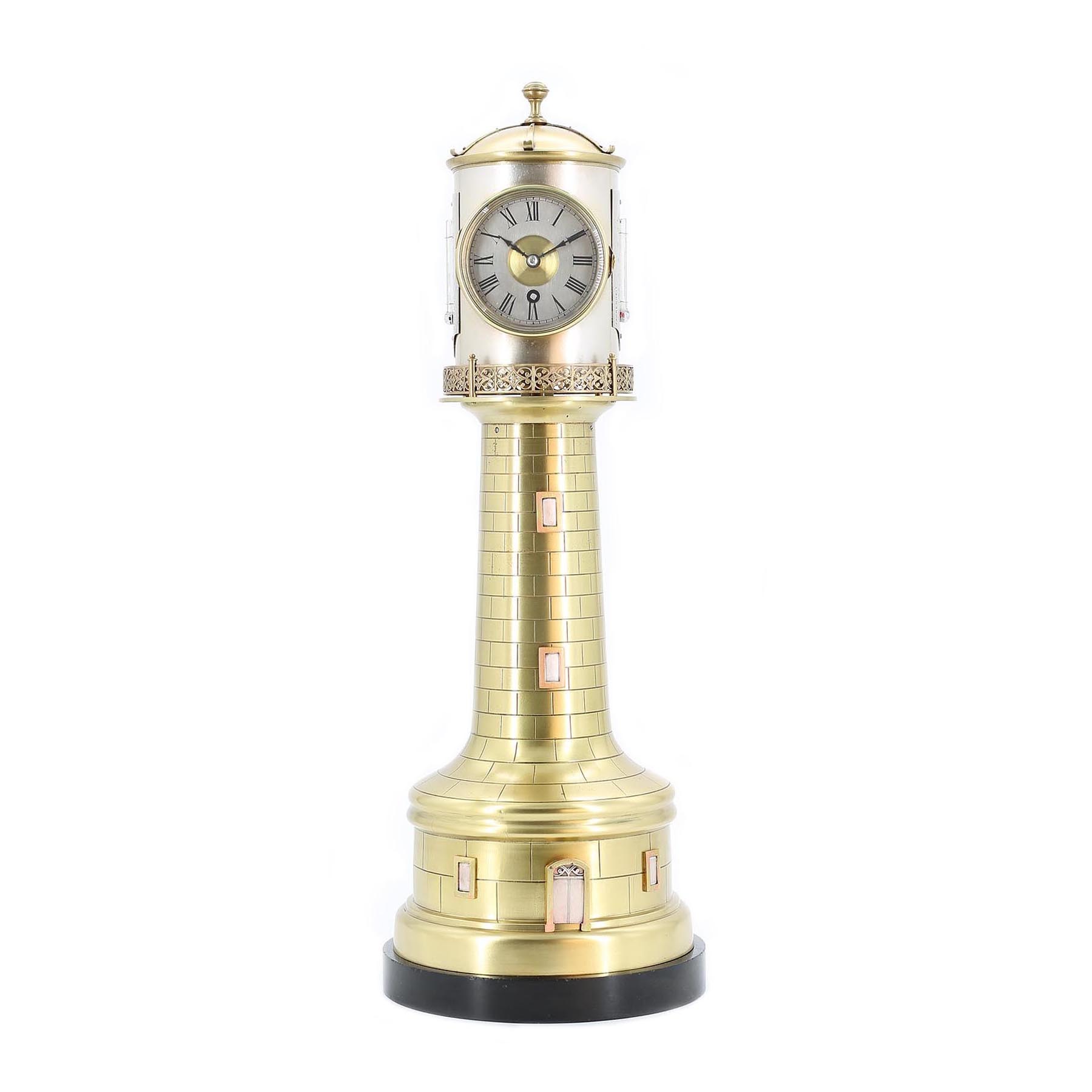 French Automata Lighthouse Clock A wonderful 19th-century novelty clock by Andre Romain Guilmet of Paris, who was famous for producing various industrial-themed mantel clocks. 8-day timepiece movement that is wound through the opening bezel, which also facilitates hand adjustment. Silvered dial with painted Roman numerals, and original matching blued steel hands. At the base of the lighthouse, there is a second movement that drives the rotating top of the lighthouse for a few hours, revealing an aneroid barometer with a similar silvered dial that opposes the clock. To the sides of the drum are two thermometers, one reading Fahrenheit and the other Centigrade, both with silvered register plates. The case is of all-brass construction sitting on a black slate base. These clocks appear on the market with different surface finishes, some gilded, silver-plated, silvered, and some of natural brass. This example shows no evidence of ever being gilded or silver plated, and so the case has been lightly polished and then lacquered to protect from fingerprints. The drum has been silvered, which is in keeping with traces of the original silvering. C.1885 Height: 17” 43.5cm £ 9,500